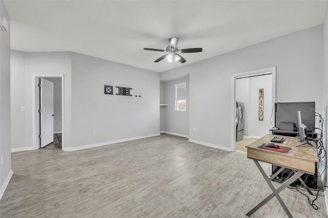 office featuring washer and clothes dryer, light hardwood / wood-style flooring, and ceiling fan