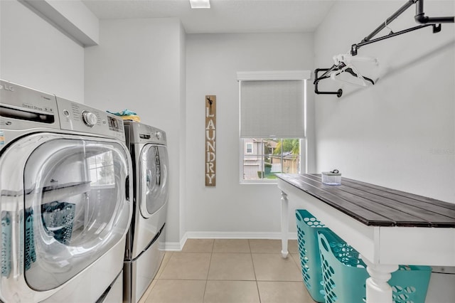 laundry room with separate washer and dryer and light tile patterned floors