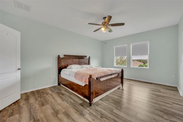 bedroom with light wood-type flooring and ceiling fan