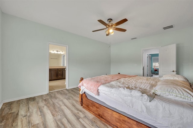 bedroom featuring connected bathroom, light hardwood / wood-style floors, and ceiling fan