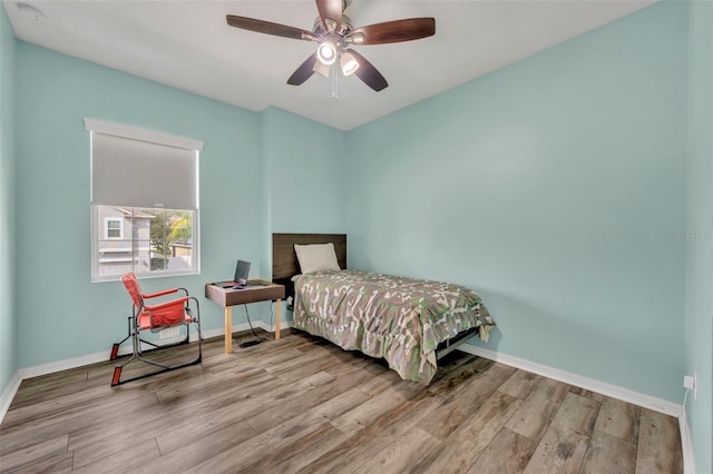 bedroom with light hardwood / wood-style floors and ceiling fan