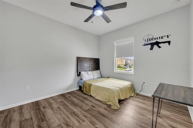 bedroom with wood-type flooring and ceiling fan