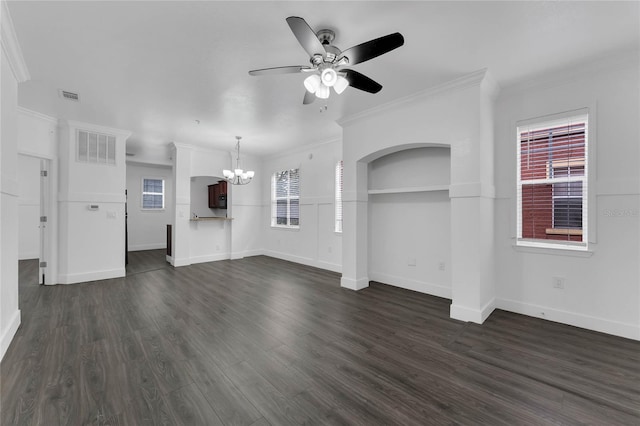 unfurnished living room with ceiling fan with notable chandelier, dark wood-style flooring, visible vents, and crown molding