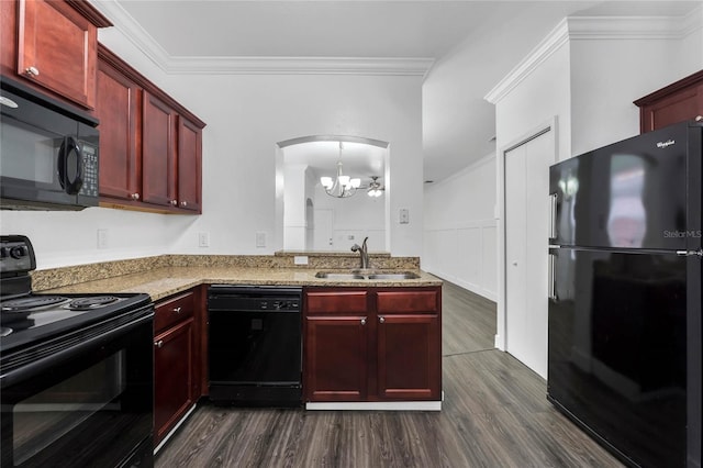kitchen featuring a sink, a chandelier, reddish brown cabinets, dark wood-type flooring, and black appliances