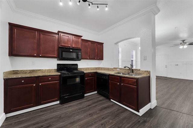kitchen with dark brown cabinets, a sink, black appliances, arched walkways, and dark wood-type flooring
