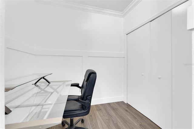 unfurnished office with wood finished floors and crown molding