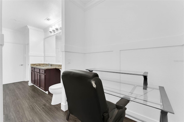 office with visible vents, a sink, dark wood-type flooring, and crown molding