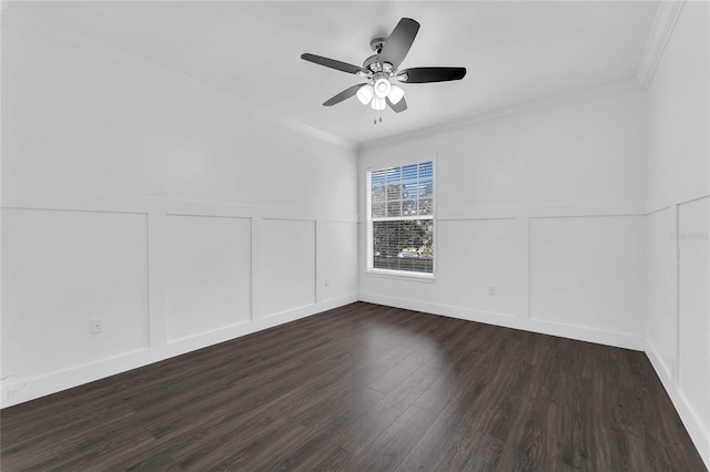 unfurnished room featuring a decorative wall, crown molding, a wainscoted wall, and dark wood-type flooring
