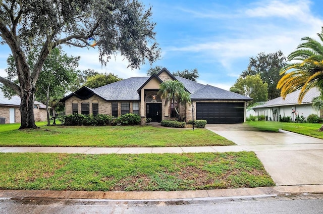 view of front of house featuring a garage and a front lawn