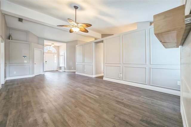 unfurnished living room featuring ceiling fan and dark hardwood / wood-style flooring