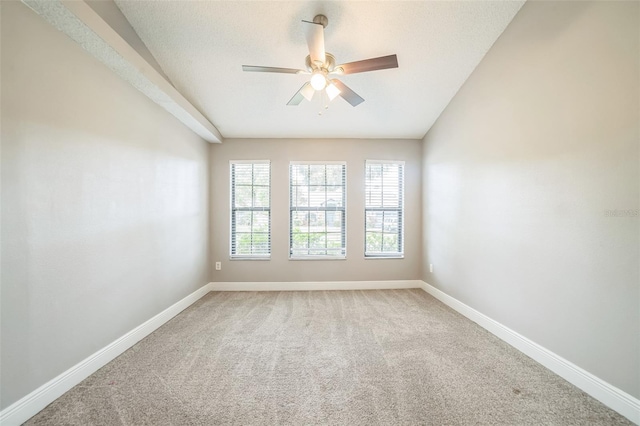 carpeted spare room with ceiling fan