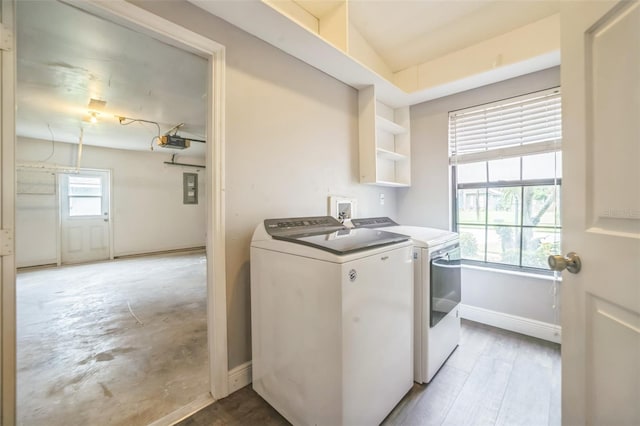 washroom with electric panel and washer and clothes dryer