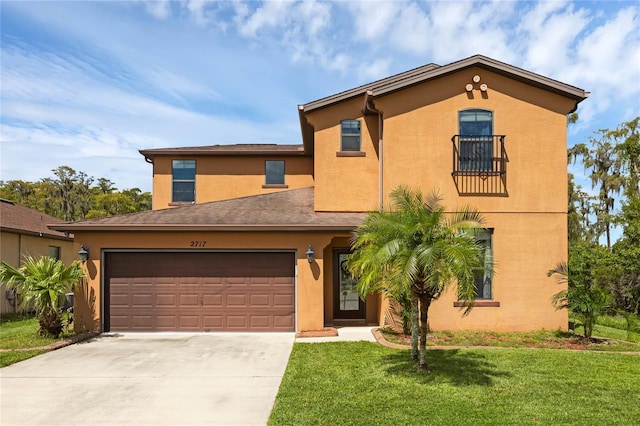 mediterranean / spanish-style home with driveway, a front lawn, and stucco siding