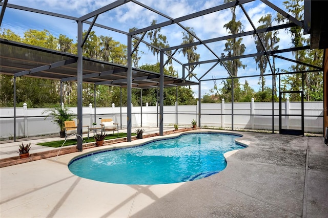 view of swimming pool featuring a lanai and a patio area