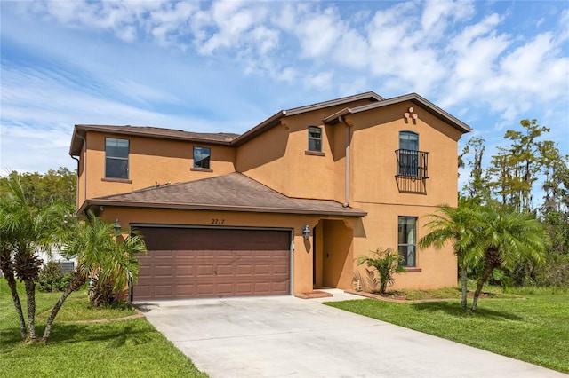 mediterranean / spanish-style house with a garage, concrete driveway, a front yard, and stucco siding