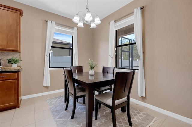 tiled dining space featuring a chandelier