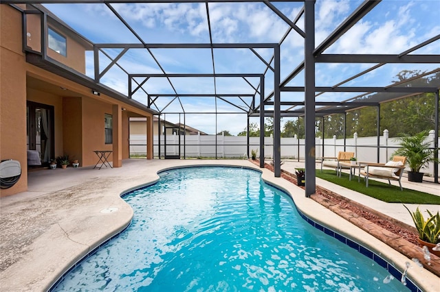 view of pool with glass enclosure and a patio