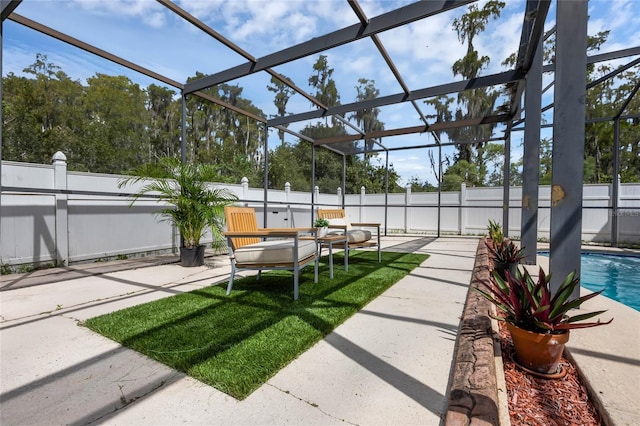 view of yard with glass enclosure, a fenced in pool, and a patio area