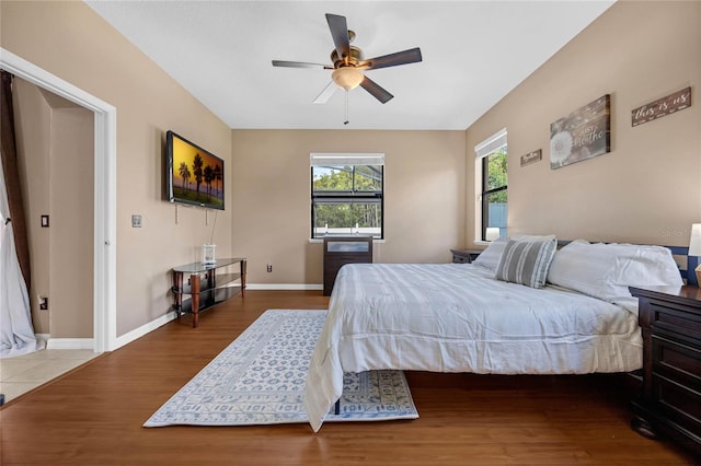 bedroom with ceiling fan and wood-type flooring