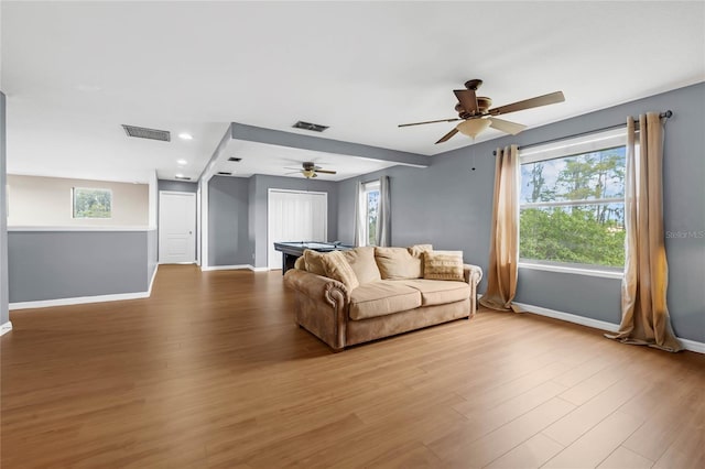 living room with light wood-type flooring and ceiling fan