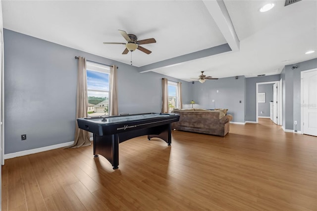 playroom with a ceiling fan, visible vents, baseboards, and wood finished floors