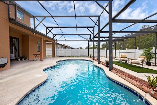 view of pool featuring glass enclosure, a patio area, fence, and a fenced in pool