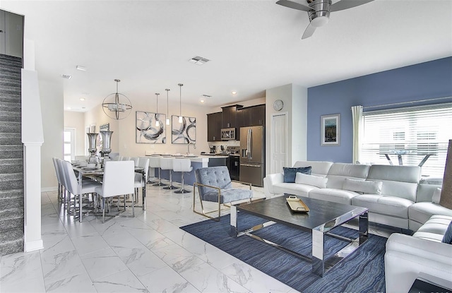 living room featuring ceiling fan and sink