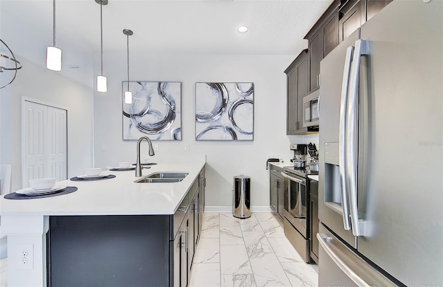 kitchen with pendant lighting, sink, dark brown cabinets, appliances with stainless steel finishes, and a center island