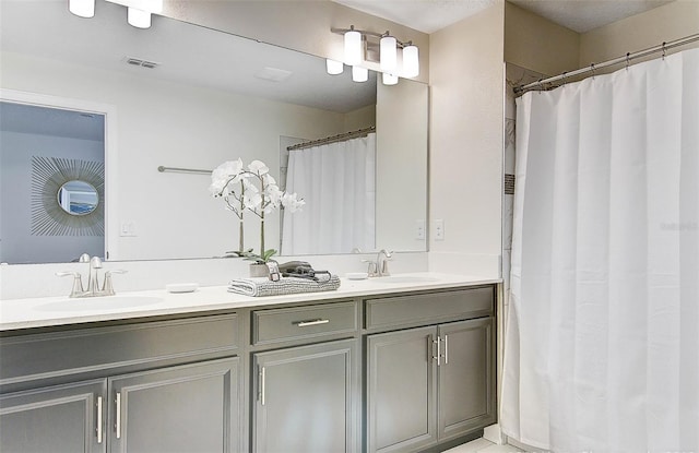 bathroom with a shower with curtain and vanity