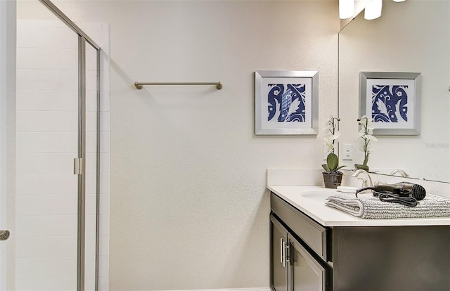 bathroom with vanity and a shower with shower door