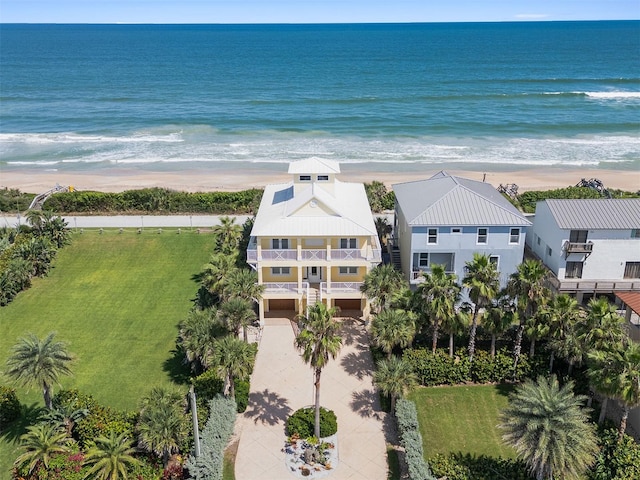 bird's eye view featuring a water view and a beach view