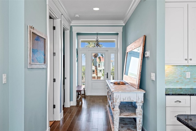 foyer with crown molding and dark hardwood / wood-style floors