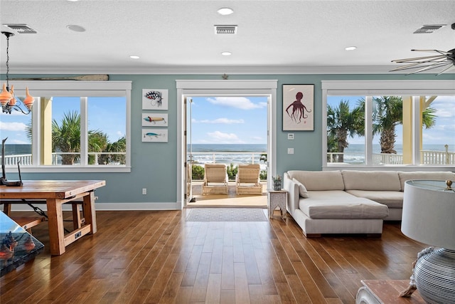 living room featuring a water view and a wealth of natural light