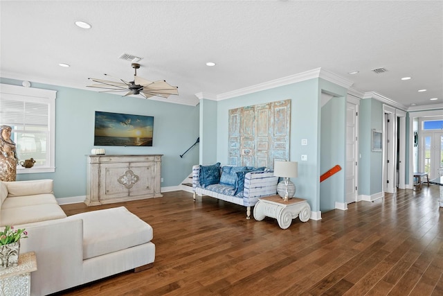 living room with ornamental molding, dark hardwood / wood-style floors, and ceiling fan