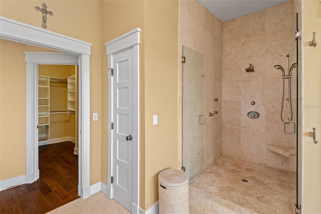 bathroom with hardwood / wood-style floors and walk in shower