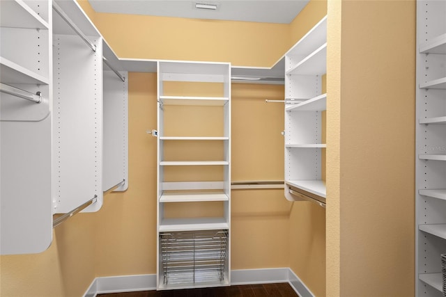 walk in closet featuring dark wood-type flooring