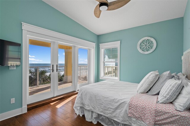 bedroom with ceiling fan, access to outside, multiple windows, and dark hardwood / wood-style floors