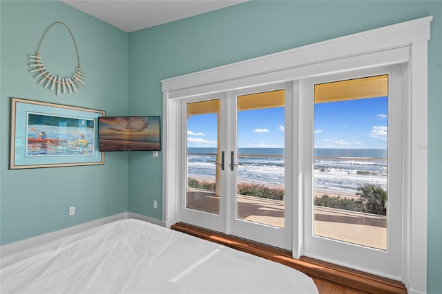 unfurnished bedroom featuring access to outside, french doors, and hardwood / wood-style flooring