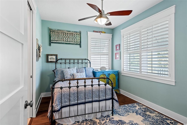 bedroom with ceiling fan and dark hardwood / wood-style floors