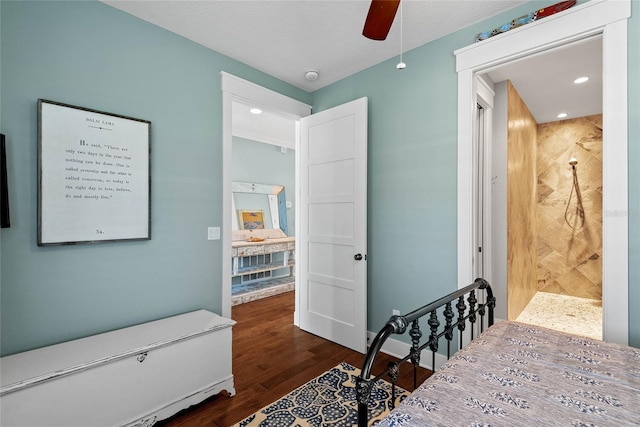 bedroom featuring connected bathroom, dark hardwood / wood-style floors, and ceiling fan