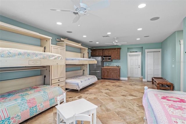 bedroom featuring stainless steel fridge and ceiling fan