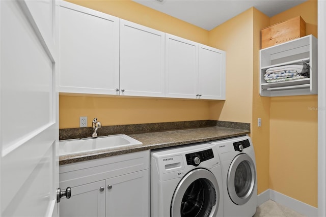 washroom with sink, cabinets, and separate washer and dryer