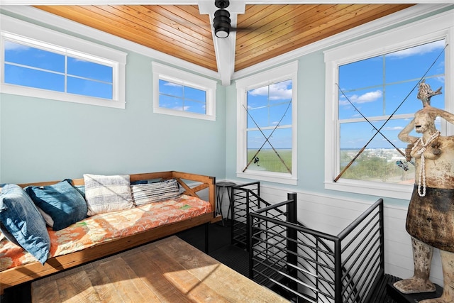 living room with a wealth of natural light, hardwood / wood-style floors, wooden walls, and wooden ceiling