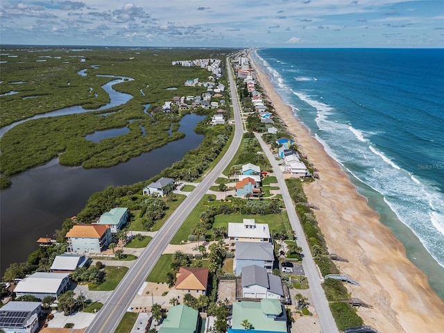 aerial view with a water view and a beach view