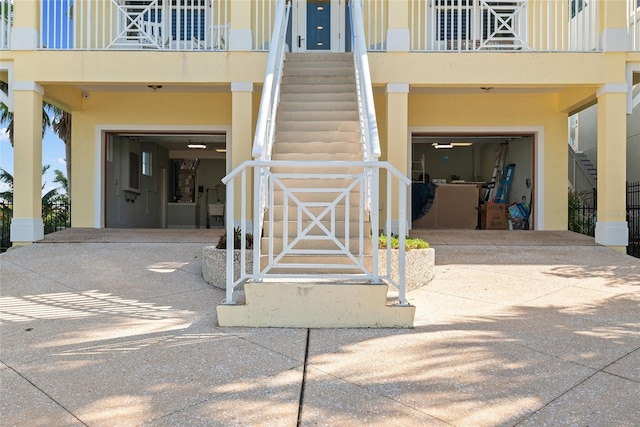 property entrance featuring a garage and a balcony