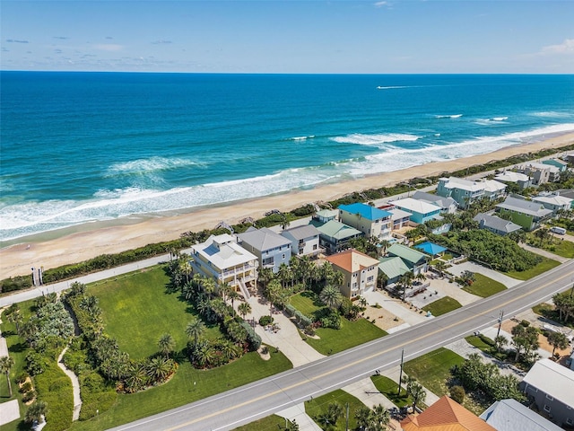 birds eye view of property featuring a water view and a view of the beach