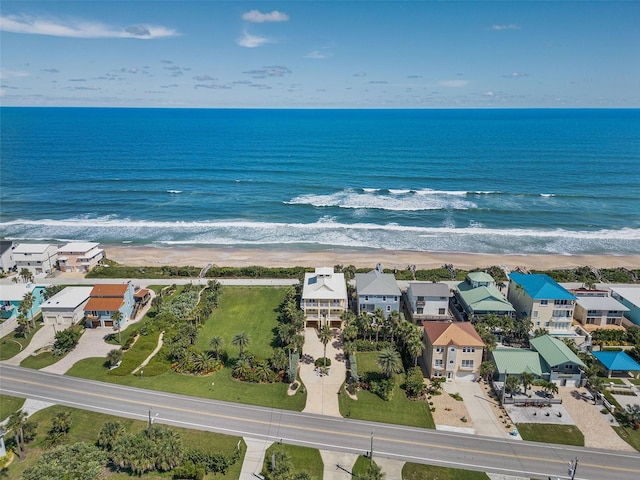 drone / aerial view with a water view and a beach view