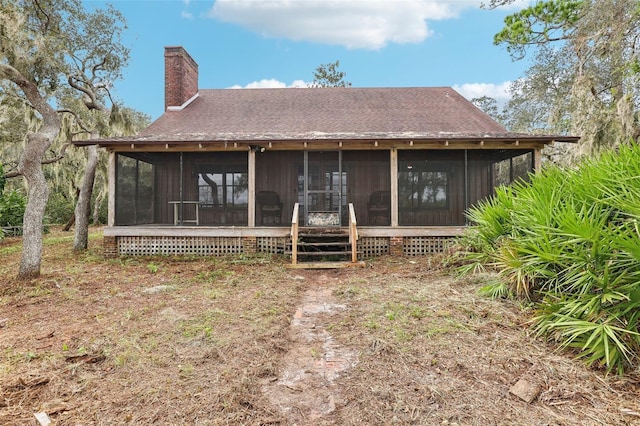 back of house featuring a sunroom