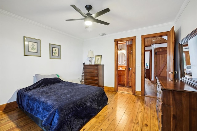 bedroom featuring ceiling fan, light wood-type flooring, ornamental molding, and ensuite bath