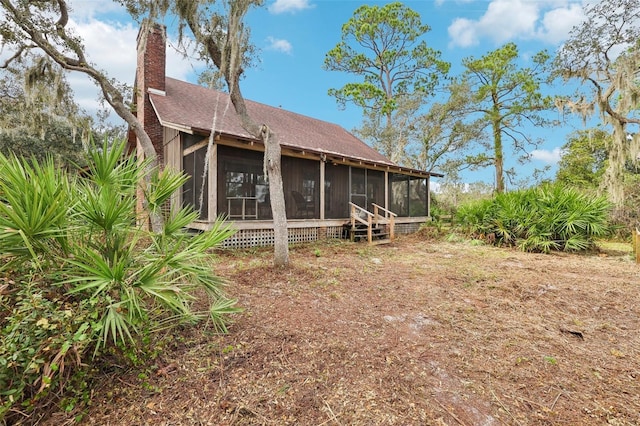 rear view of house with a sunroom